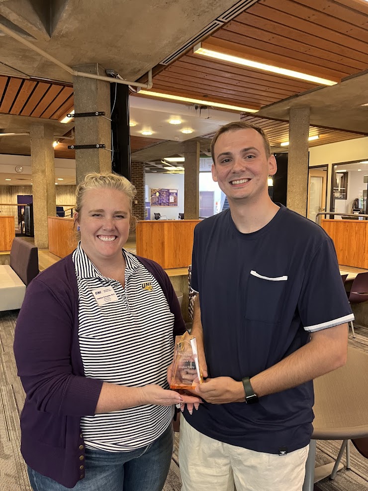 Josh Farris receives the Rising Star Award from Heather Schroeder.